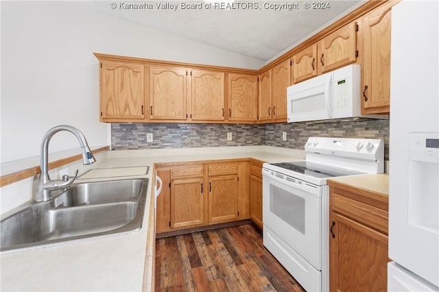 kitchen featuring sink, vaulted ceiling, dark hardwood / wood-style flooring, white appliances, and tasteful backsplash