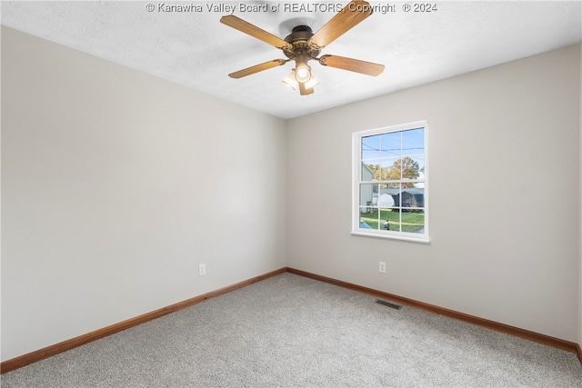 carpeted empty room featuring a textured ceiling and ceiling fan