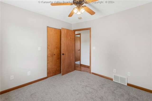 unfurnished bedroom featuring carpet flooring, a closet, and ceiling fan