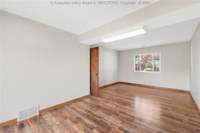 empty room with hardwood / wood-style flooring