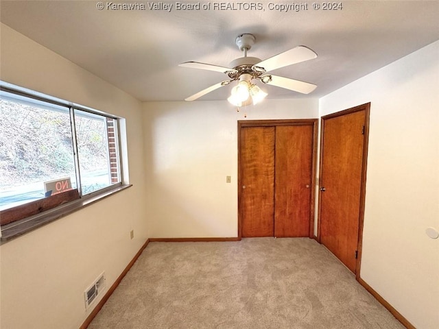 1526 Trace Fork Rd, South Charleston, WV 25309 - unfurnished bedroom with light colored carpet, a closet, and ceiling fan