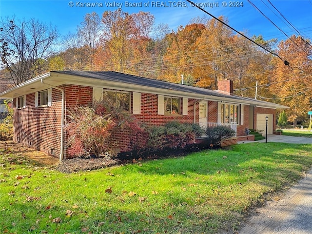 single story home with a front yard and a garage