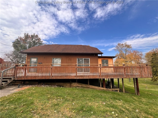 back of property featuring a yard and a deck