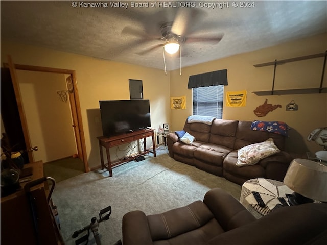 carpeted living room featuring a textured ceiling and ceiling fan