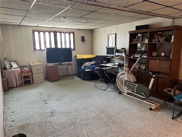 interior space with a paneled ceiling and carpet floors