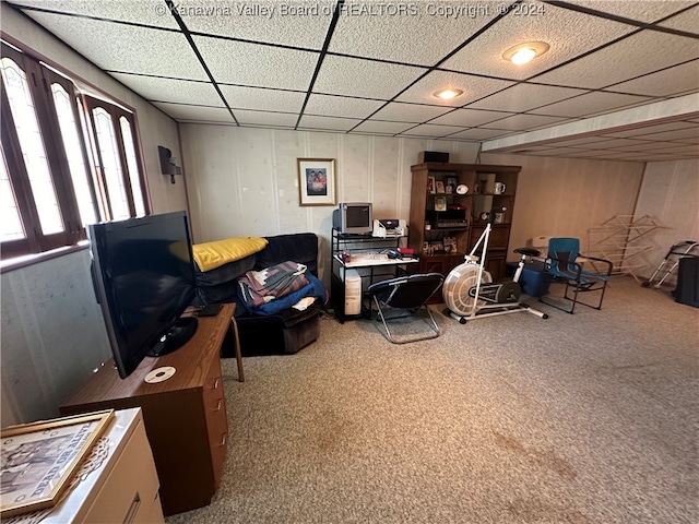 carpeted home office with a drop ceiling