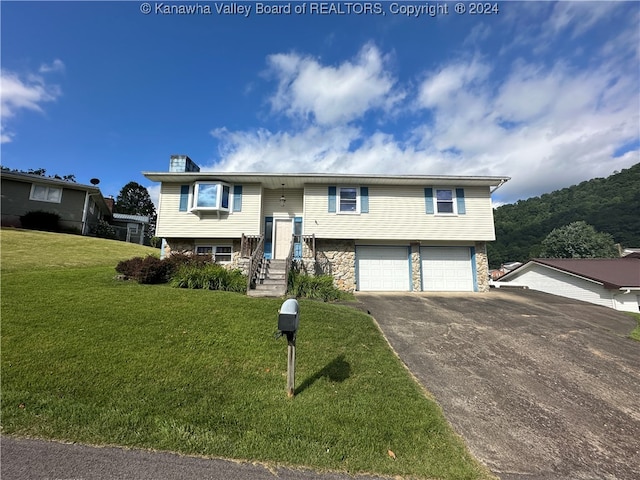 bi-level home with a front yard and a garage