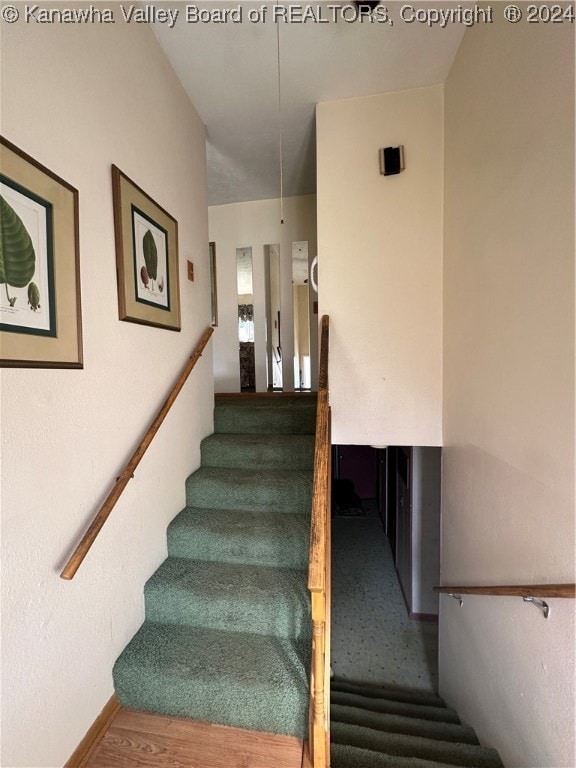 stairs featuring hardwood / wood-style flooring