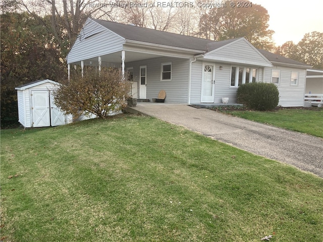 view of front facade featuring a shed, a front lawn, and a carport