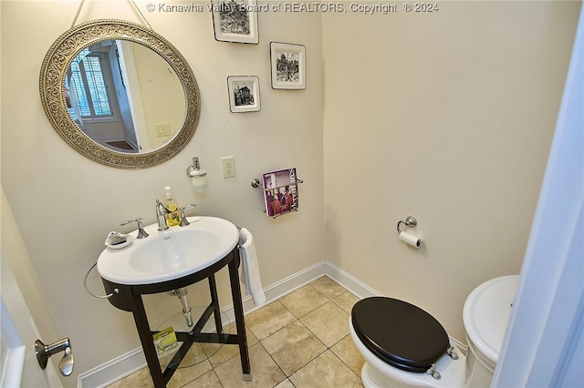 bathroom with toilet and tile patterned floors