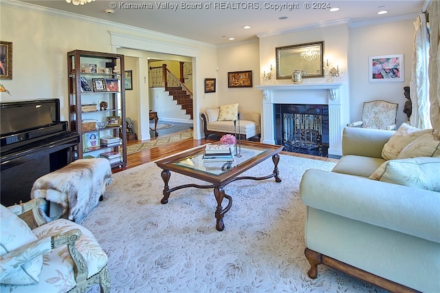 living room featuring crown molding and light wood-type flooring