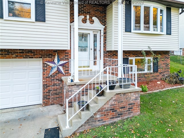 doorway to property with a garage