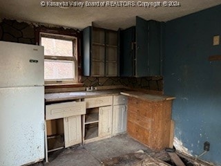 kitchen featuring white fridge