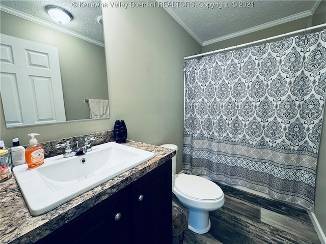 bathroom featuring vanity, toilet, ornamental molding, and a textured ceiling