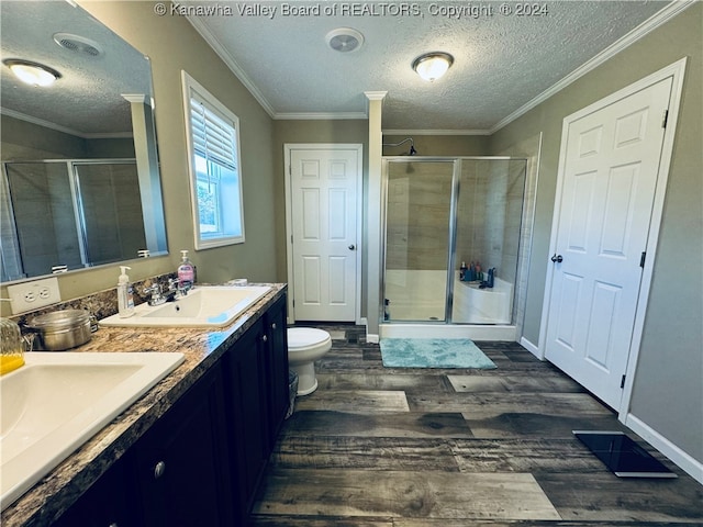 bathroom with toilet, a shower with shower door, and hardwood / wood-style floors