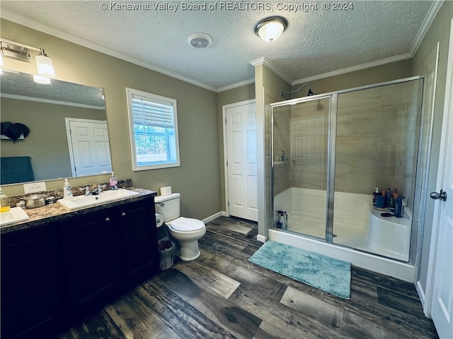 bathroom with vanity, toilet, a shower with shower door, and hardwood / wood-style floors