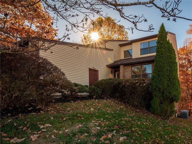 property exterior at dusk featuring central air condition unit