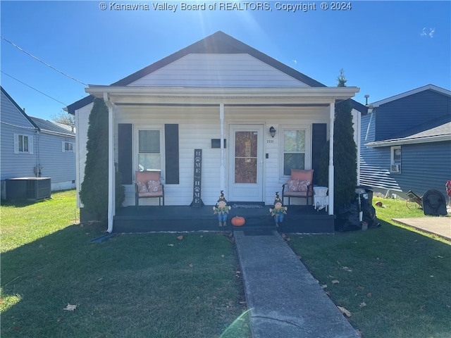 bungalow-style house featuring a porch, central AC, and a front yard