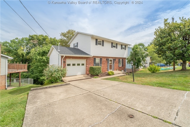 view of front of house with a garage, a front yard, and a wooden deck