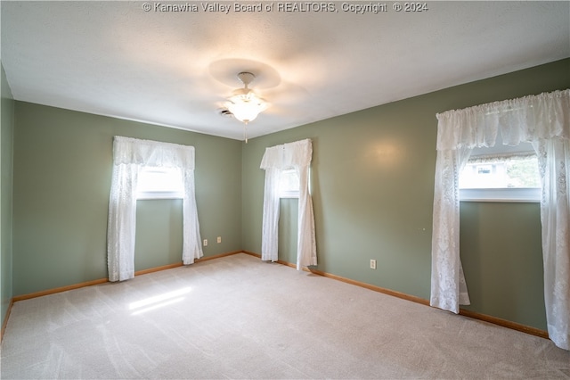 carpeted empty room featuring a textured ceiling