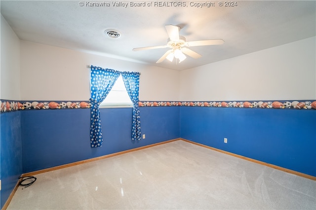 empty room with ceiling fan and carpet floors