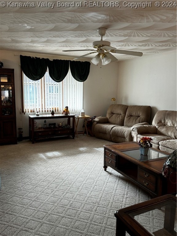 carpeted living room with ceiling fan