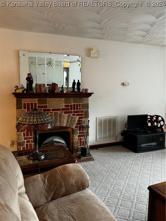 living room featuring a fireplace and ceiling fan