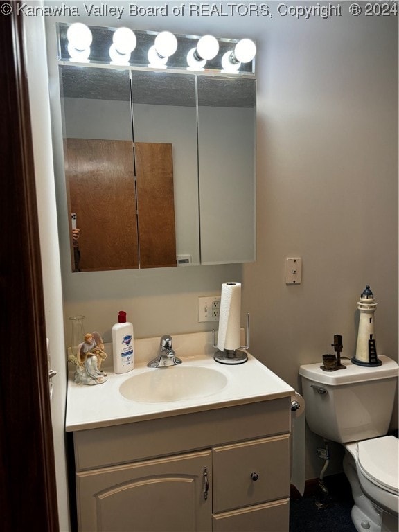 bathroom featuring vanity and toilet