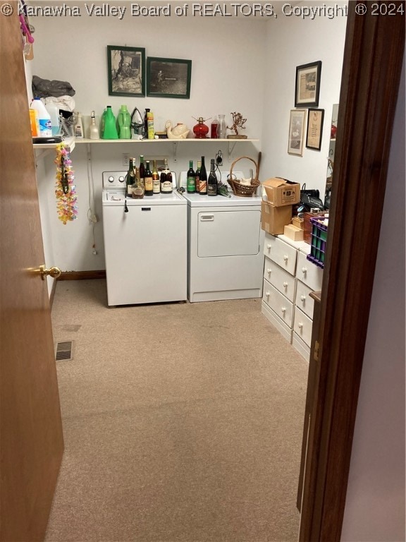 laundry room with washing machine and dryer and light carpet