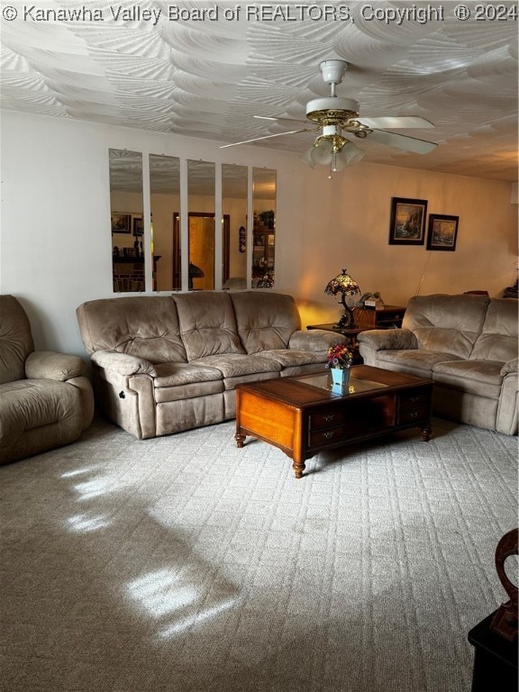 living room featuring ceiling fan and carpet