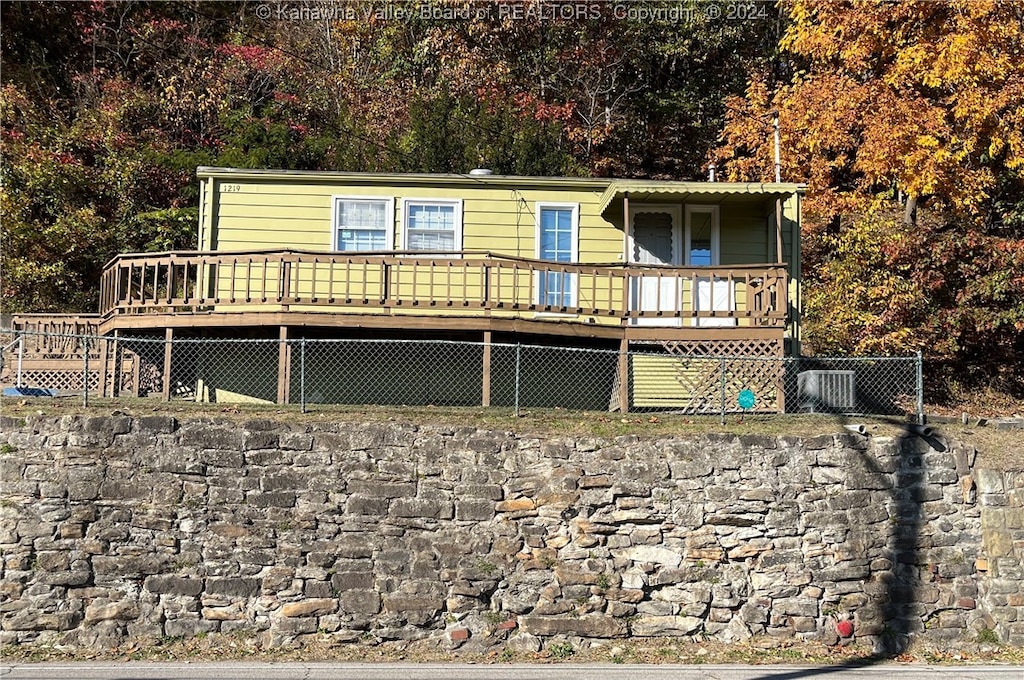 rear view of house with a wooden deck