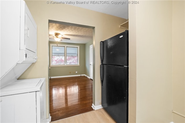 kitchen with black fridge, wood-type flooring, a textured ceiling, and ceiling fan