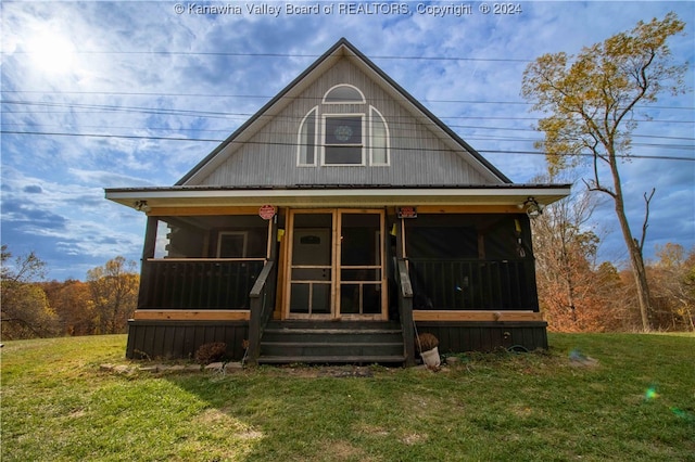 view of front of home with a front yard and a sunroom