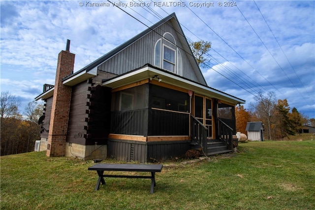 view of front of house with a front yard and a sunroom