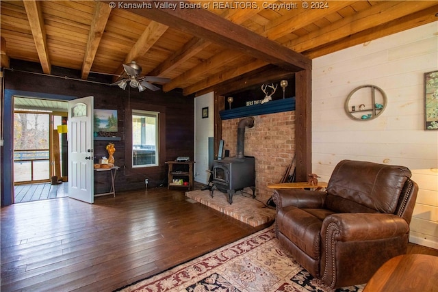 unfurnished living room with a wealth of natural light, wood-type flooring, and a wood stove