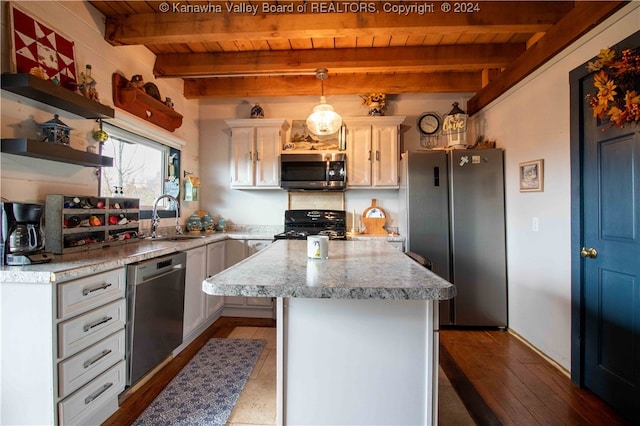 kitchen featuring appliances with stainless steel finishes, beamed ceiling, a center island, and wood ceiling