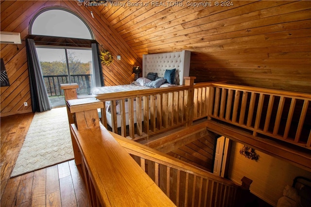 staircase with hardwood / wood-style floors, wood walls, wood ceiling, and lofted ceiling