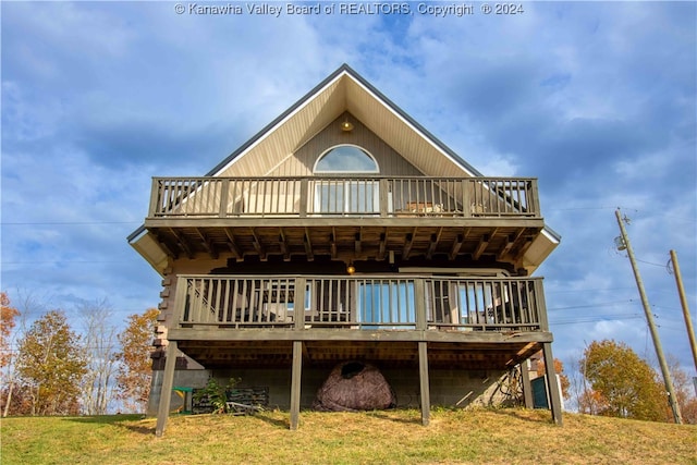 back of house with a yard and a wooden deck