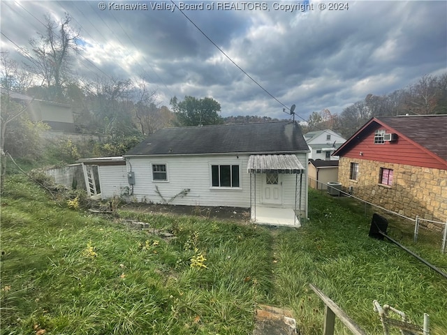 rear view of property featuring central AC