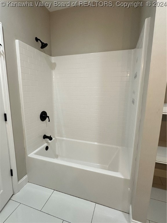 bathroom with tile patterned floors and tiled shower / bath combo