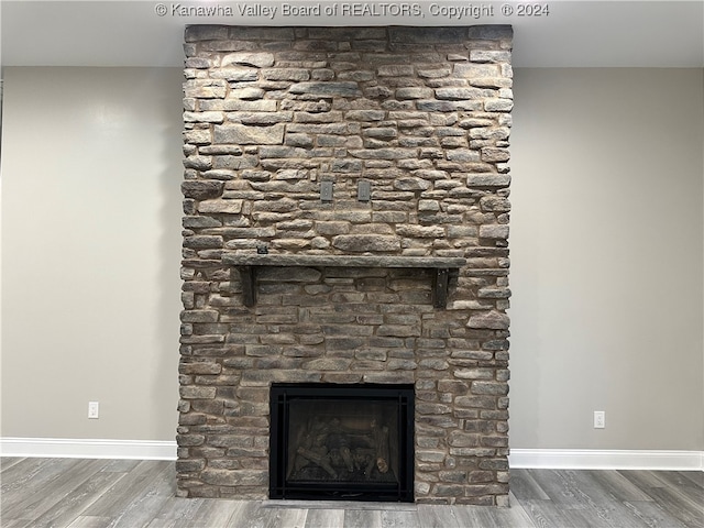 interior details with hardwood / wood-style flooring and a fireplace