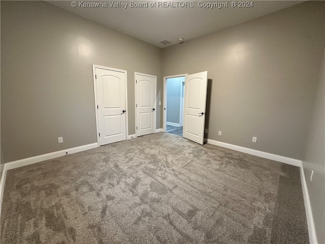 unfurnished bedroom with carpet flooring