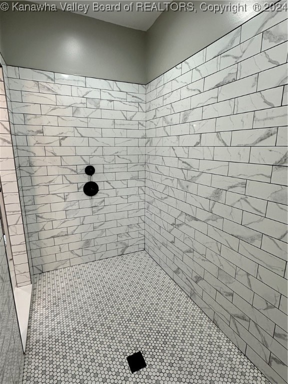 bathroom with tiled shower