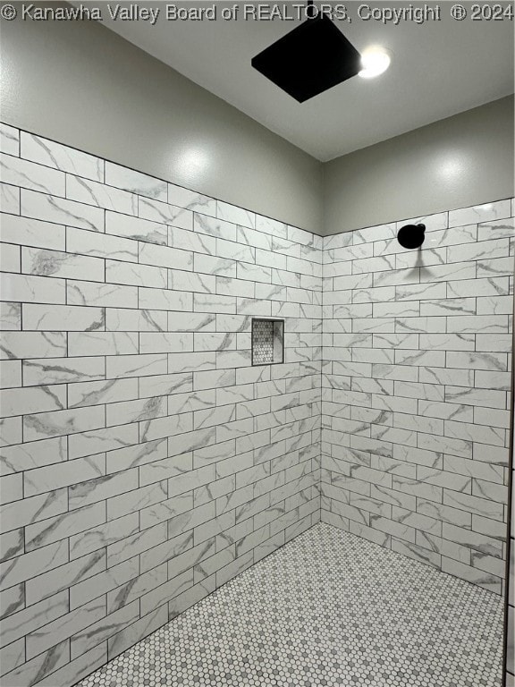 bathroom with a tile shower