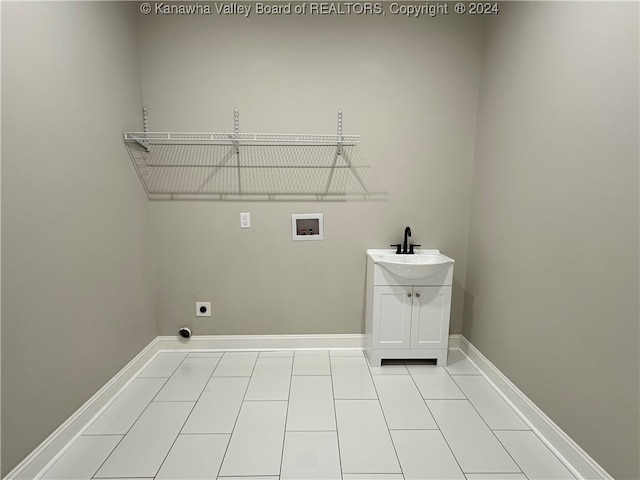 laundry room featuring light tile patterned flooring, washer hookup, hookup for an electric dryer, and sink