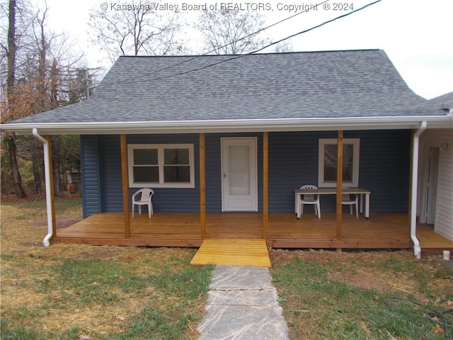 exterior space with a front lawn and a porch