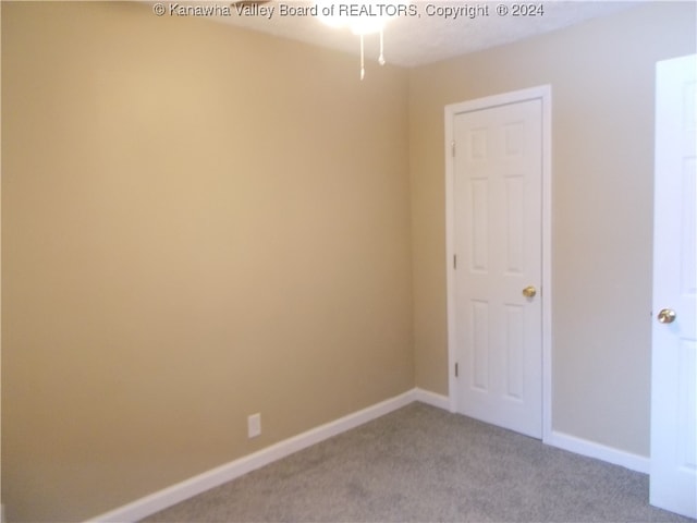 empty room featuring light carpet