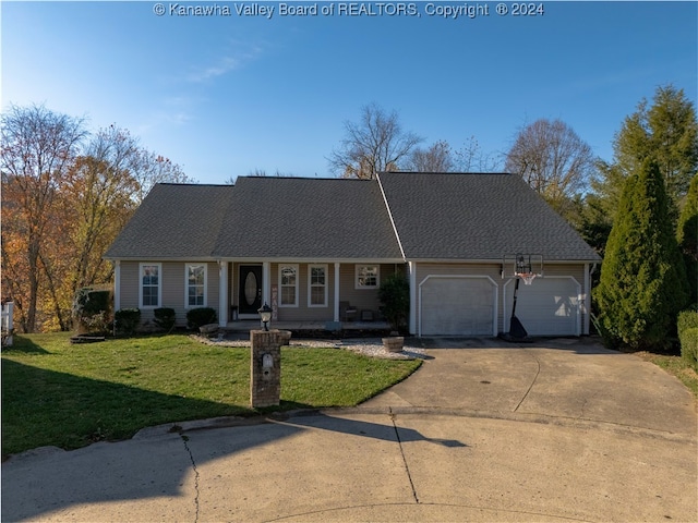 ranch-style house with a garage, a front lawn, and covered porch