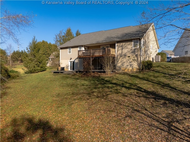 rear view of house featuring a wooden deck, central AC, and a yard