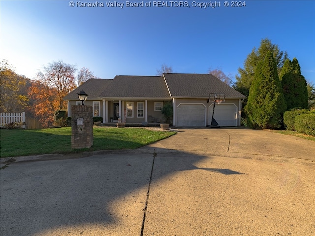 ranch-style house featuring a garage and a front yard